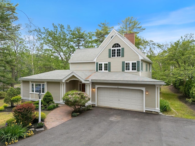21 Glenhaven Cir W, Saco, ME 04072 - view of front of home featuring driveway, a chimney, and an attached garage