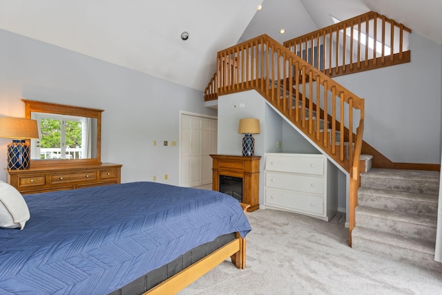 21 Glenhaven Cir W, Saco, ME 04072 - carpeted bedroom with high vaulted ceiling, a glass covered fireplace, a closet, and recessed lighting