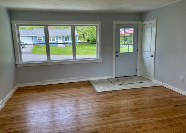 10 Crawford Dr, Bath, ME 04530 - entryway featuring baseboard heating, wood finished floors, baseboards, and crown molding