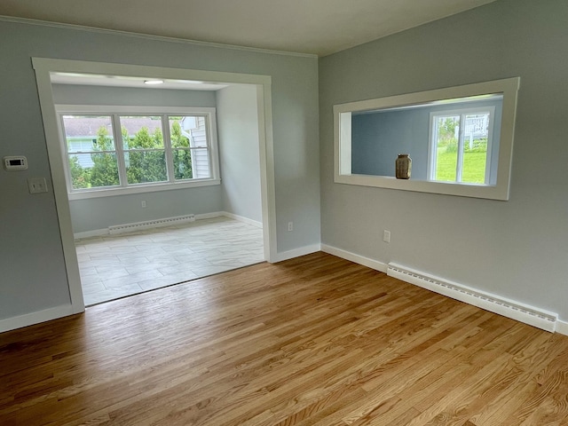 10 Crawford Dr, Bath, ME 04530 - unfurnished room featuring baseboard heating, a baseboard heating unit, baseboards, crown molding, and wood finished floors