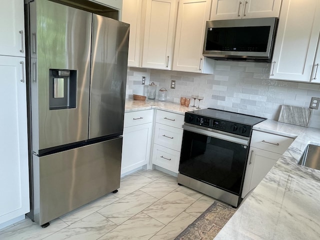 10 Crawford Dr, Bath, ME 04530 - kitchen featuring appliances with stainless steel finishes, light marble finish floors, light stone countertops, and backsplash