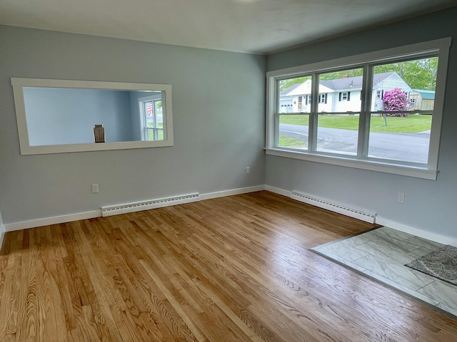 10 Crawford Dr, Bath, ME 04530 - unfurnished room featuring a baseboard heating unit, plenty of natural light, and wood finished floors