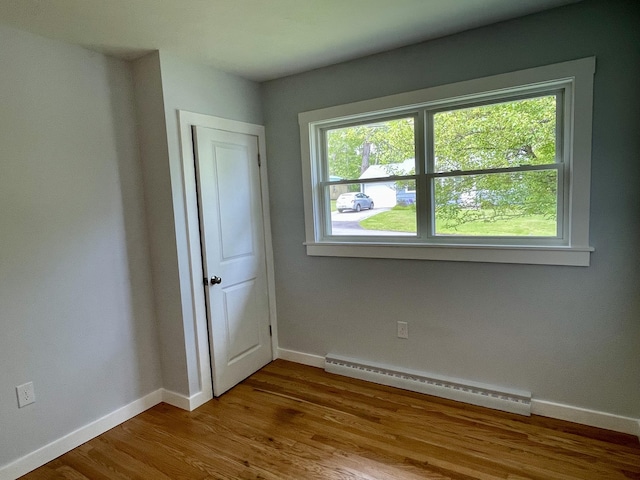 10 Crawford Dr, Bath, ME 04530 - empty room with baseboard heating, baseboards, and wood finished floors