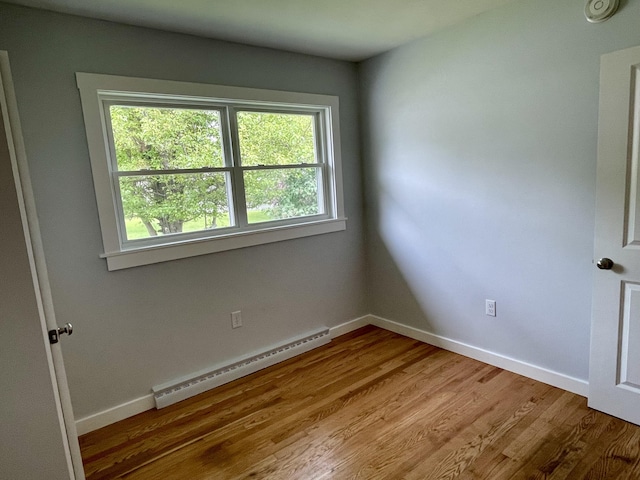 10 Crawford Dr, Bath, ME 04530 - unfurnished room with baseboard heating, plenty of natural light, wood finished floors, and baseboards