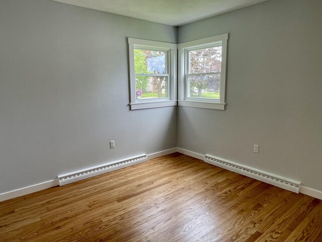 10 Crawford Dr, Bath, ME 04530 - unfurnished room with a baseboard radiator, wood finished floors, and baseboards