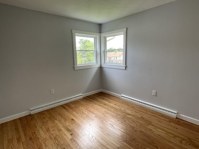 10 Crawford Dr, Bath, ME 04530 - unfurnished room with baseboard heating, a baseboard heating unit, light wood-style floors, and baseboards