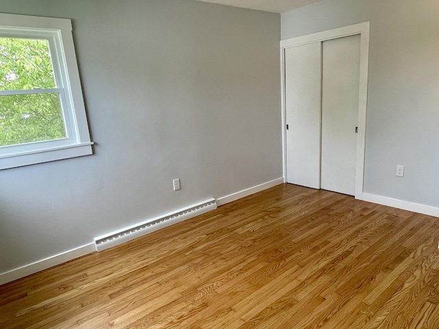 10 Crawford Dr, Bath, ME 04530 - empty room featuring a baseboard heating unit, wood finished floors, and baseboards