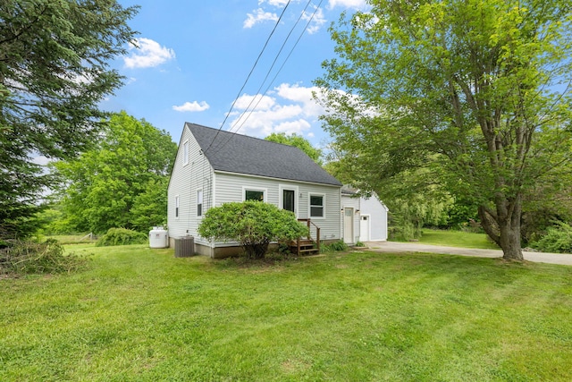 156 Lebanon Rd, North Berwick, ME 03906 - view of front of home featuring central AC, a shingled roof, a front lawn, and a garage