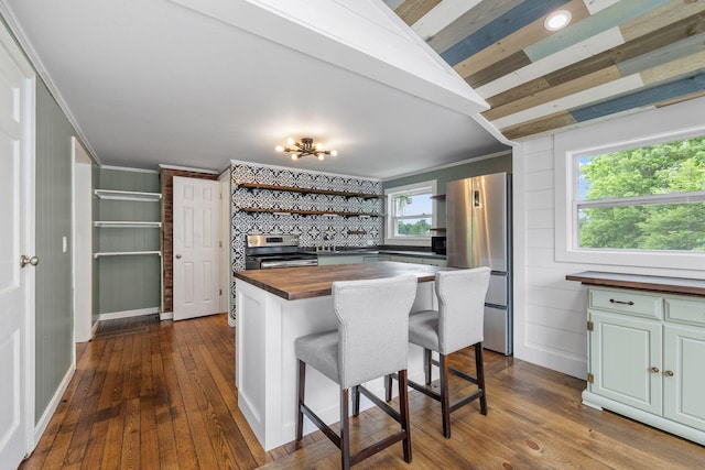 156 Lebanon Rd, North Berwick, ME 03906 - kitchen with butcher block countertops, stainless steel appliances, open shelves, ornamental molding, and dark wood finished floors