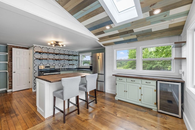 156 Lebanon Rd, North Berwick, ME 03906 - kitchen with wood counters, wine cooler, appliances with stainless steel finishes, open shelves, and vaulted ceiling