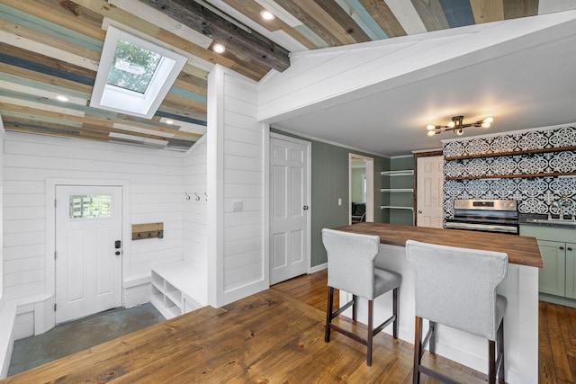 156 Lebanon Rd, North Berwick, ME 03906 - kitchen with wooden counters, stainless steel range with electric stovetop, dark wood-style flooring, a skylight, and wooden walls