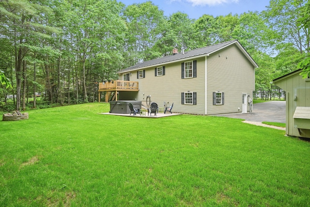 76 Bunny St, Augusta, ME 04330 - back of house featuring a patio area, a chimney, a lawn, a hot tub, and a deck