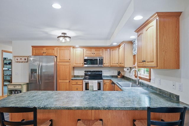 76 Bunny St, Augusta, ME 04330 - kitchen featuring appliances with stainless steel finishes, a sink, a breakfast bar, recessed lighting, and a peninsula