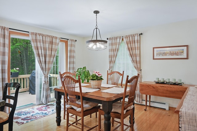 76 Bunny St, Augusta, ME 04330 - dining space featuring baseboard heating, light wood-style flooring, and a chandelier