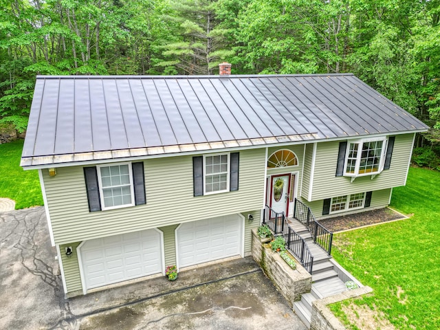 76 Bunny St, Augusta, ME 04330 - split foyer home featuring a standing seam roof, metal roof, and driveway