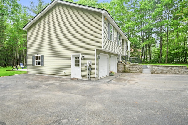 76 Bunny St, Augusta, ME 04330 - view of side of property featuring an attached garage and driveway