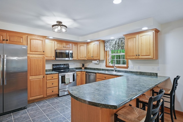 76 Bunny St, Augusta, ME 04330 - kitchen featuring stainless steel appliances, a sink, dark countertops, a breakfast bar area, and recessed lighting