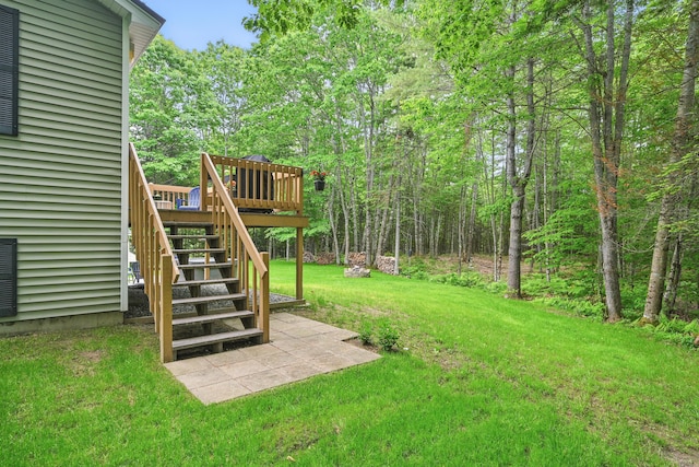 76 Bunny St, Augusta, ME 04330 - view of grassy yard with stairway, a wooden deck, and a patio area