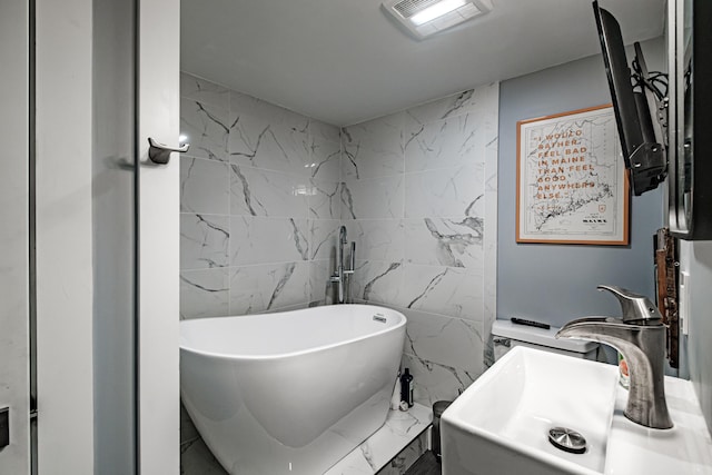 156 Oxford St, Portland, ME 04101 - full bath featuring tile walls, a freestanding bath, marble finish flooring, and a sink