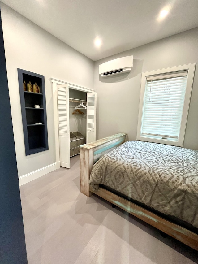 156 Oxford St, Portland, ME 04101 - bedroom featuring a wall unit AC, a closet, baseboards, and recessed lighting