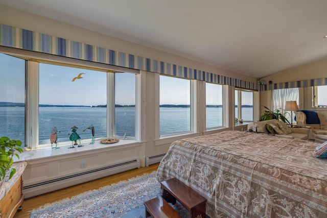 463 Seawall Rd, Southwest Harbor, ME 04679 - bedroom with baseboard heating, wood finished floors, a water view, and lofted ceiling