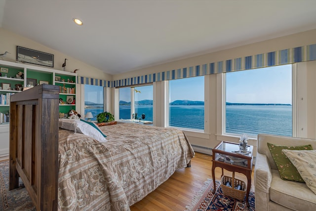 463 Seawall Rd, Southwest Harbor, ME 04679 - bedroom featuring lofted ceiling, wood finished floors, a water view, a baseboard radiator, and recessed lighting