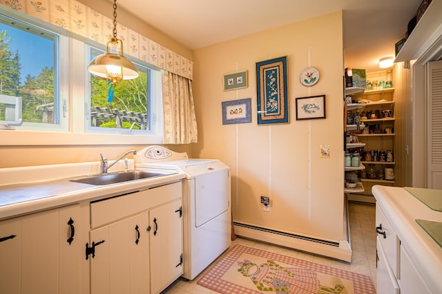 463 Seawall Rd, Southwest Harbor, ME 04679 - washroom with a baseboard heating unit, light tile patterned floors, cabinet space, and separate washer and dryer