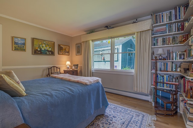 463 Seawall Rd, Southwest Harbor, ME 04679 - bedroom featuring a baseboard radiator, wood finished floors, and crown molding