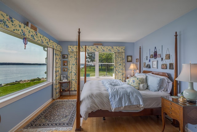 463 Seawall Rd, Southwest Harbor, ME 04679 - bedroom with wood finished floors, baseboard heating, and a water view