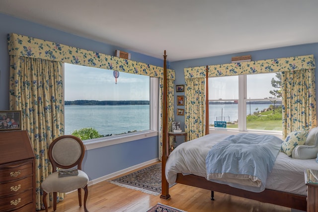463 Seawall Rd, Southwest Harbor, ME 04679 - bedroom with multiple windows, wood finished floors, and a water view