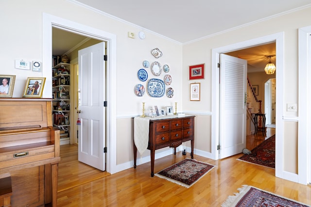 463 Seawall Rd, Southwest Harbor, ME 04679 - hall with light wood-style flooring, arched walkways, crown molding, and stairs