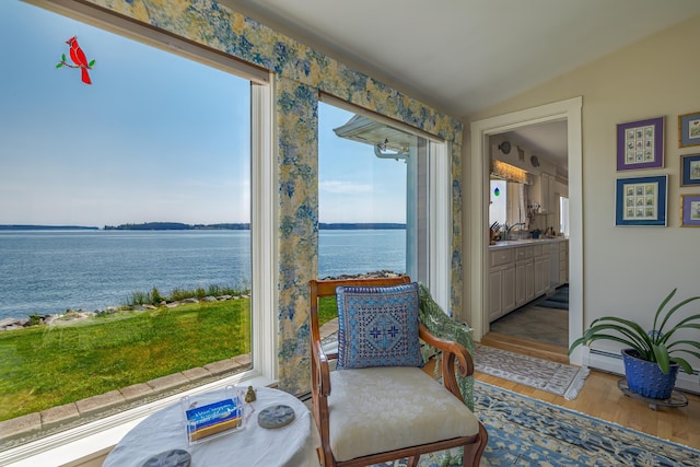 463 Seawall Rd, Southwest Harbor, ME 04679 - sitting room with a water view, wood finished floors, lofted ceiling, and a baseboard radiator