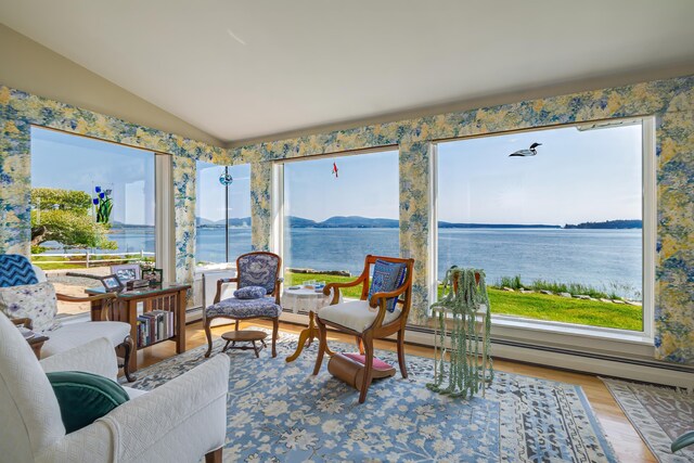 463 Seawall Rd, Southwest Harbor, ME 04679 - sunroom with lofted ceiling, a water view, and a baseboard radiator