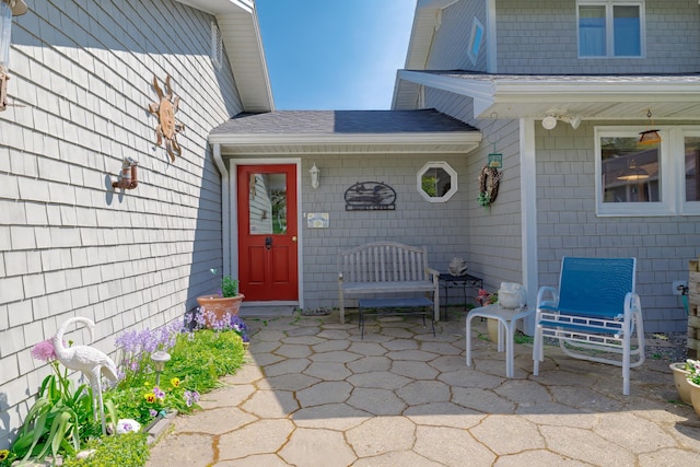 463 Seawall Rd, Southwest Harbor, ME 04679 - view of exterior entry featuring roof with shingles and a patio area