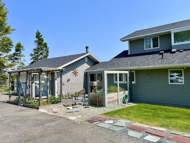 463 Seawall Rd, Southwest Harbor, ME 04679 - back of property featuring a garden, a shingled roof, and an attached garage