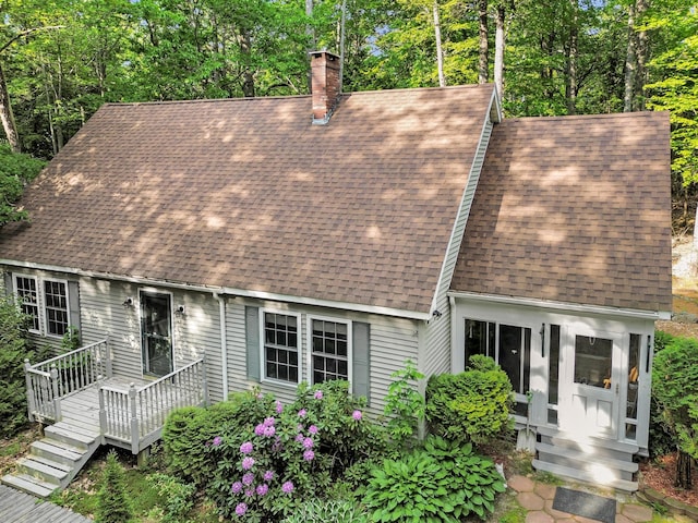 21 Heritage Ln, Orland, ME 04472 - cape cod house featuring a shingled roof, a chimney, and a wooden deck