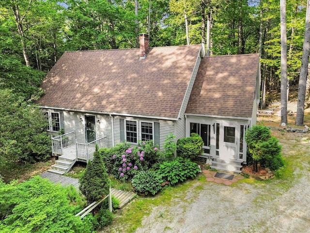 21 Heritage Ln, Orland, ME 04472 - new england style home featuring a shingled roof, a chimney, and a deck