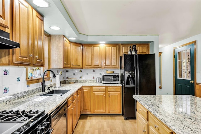 21 Heritage Ln, Orland, ME 04472 - kitchen featuring black fridge with ice dispenser, dishwashing machine, stainless steel microwave, light stone countertops, and light wood-style floors