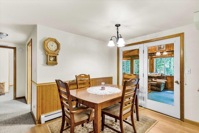 21 Heritage Ln, Orland, ME 04472 - dining area featuring a baseboard radiator, french doors, a chandelier, and light wood-type flooring