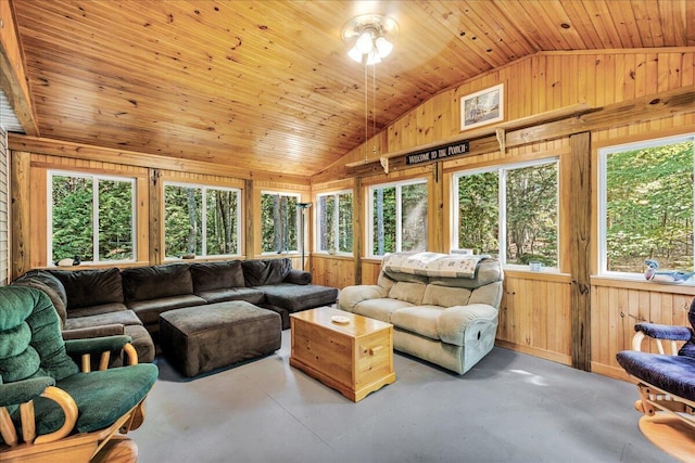 21 Heritage Ln, Orland, ME 04472 - living area featuring vaulted ceiling, wood walls, and finished concrete flooring