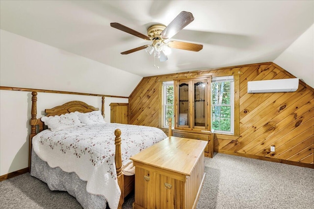 21 Heritage Ln, Orland, ME 04472 - bedroom featuring a wall unit AC, carpet floors, lofted ceiling, wood walls, and a ceiling fan