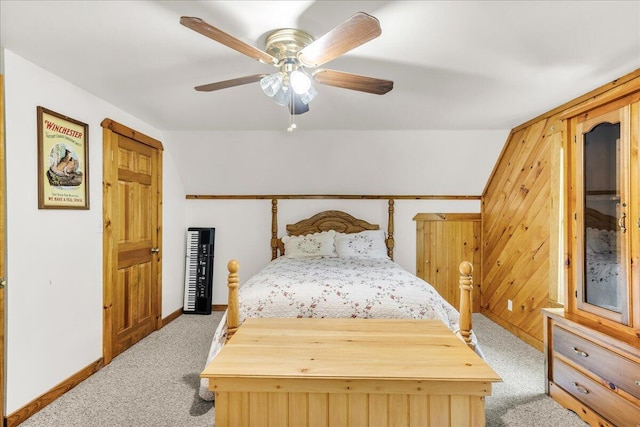 21 Heritage Ln, Orland, ME 04472 - carpeted bedroom with lofted ceiling, ceiling fan, and wood walls