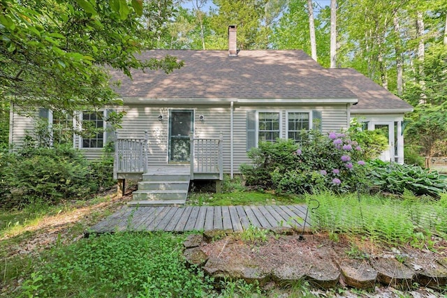 21 Heritage Ln, Orland, ME 04472 - back of property featuring a wooden deck, roof with shingles, and a chimney