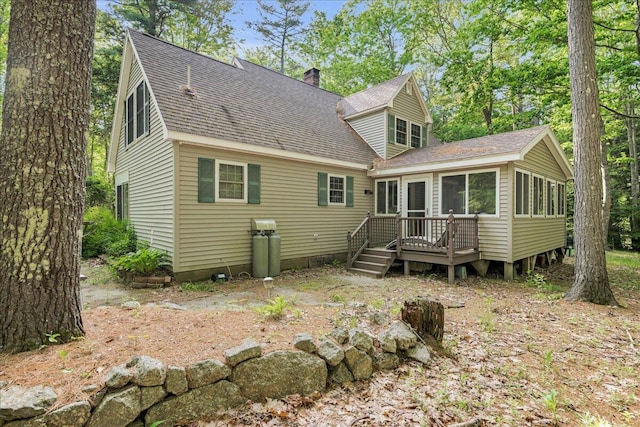 21 Heritage Ln, Orland, ME 04472 - back of house with a deck, a chimney, a sunroom, and a shingled roof