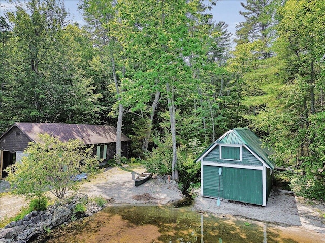 21 Heritage Ln, Orland, ME 04472 - view of yard featuring a storage unit and a wooded view