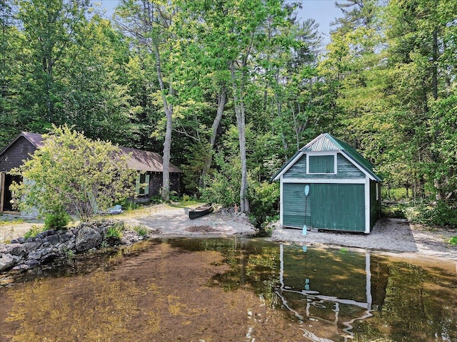 21 Heritage Ln, Orland, ME 04472 - view of yard with a storage unit and a wooded view