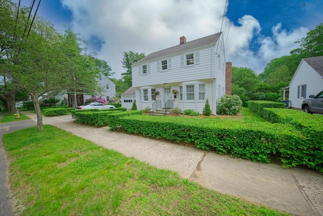 42 Sylvan Rd, South Portland, ME 04106 - colonial-style house featuring a chimney and a garage