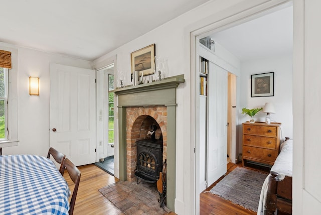 168 S Rd, Chebeague Island, ME 04017 - bedroom with a wood stove, wood finished floors, and access to outside