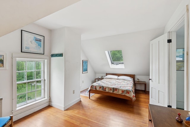 168 S Rd, Chebeague Island, ME 04017 - bedroom with a skylight, light wood-style flooring, and vaulted ceiling