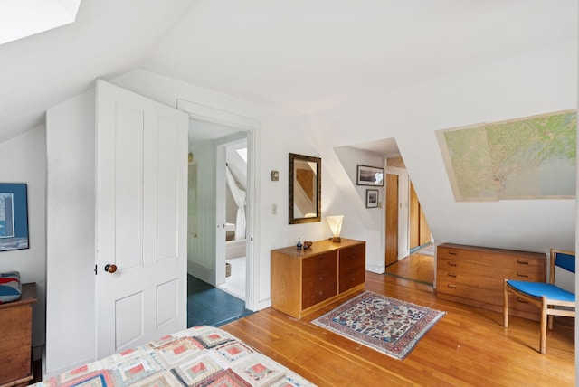 168 S Rd, Chebeague Island, ME 04017 - bedroom featuring wood finished floors, a skylight, and vaulted ceiling
